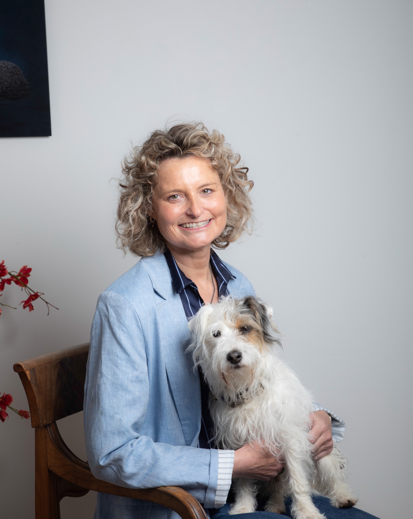Suzanne Hathaway smiling while seated with her dog